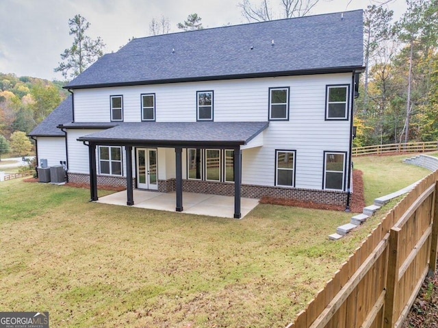 back of property featuring a patio and a yard