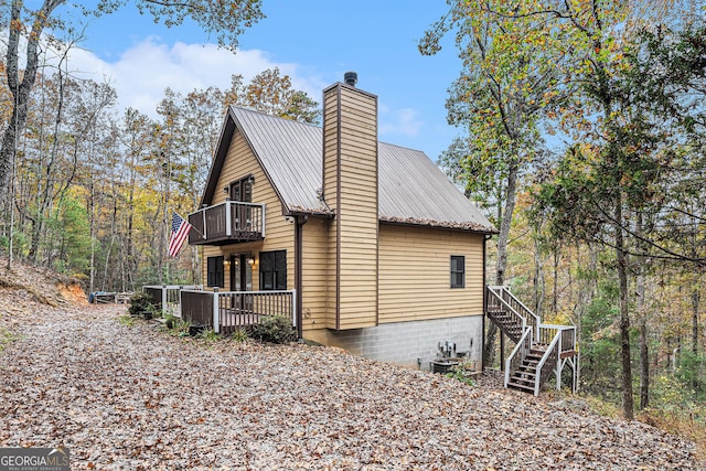 view of property exterior with a wooden deck