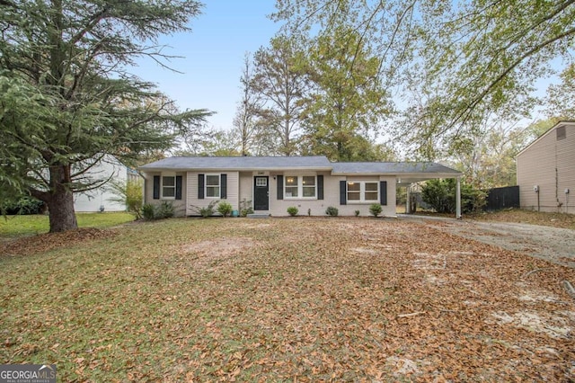 single story home featuring a front lawn and a carport