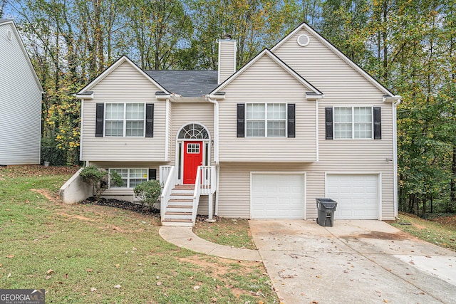 split foyer home featuring a front yard and a garage