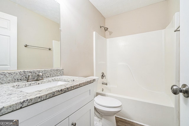 full bathroom featuring a textured ceiling, vanity, toilet, hardwood / wood-style flooring, and bathtub / shower combination