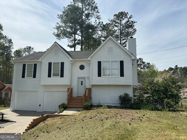 split foyer home with a garage and a front lawn