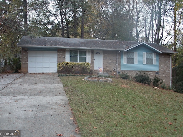 ranch-style house featuring a garage and a front lawn