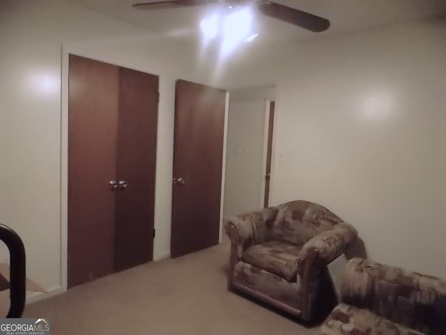 living area with ceiling fan