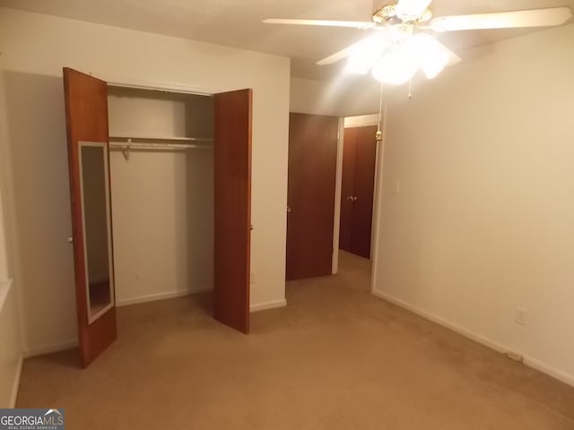 unfurnished bedroom featuring a closet, light carpet, and ceiling fan