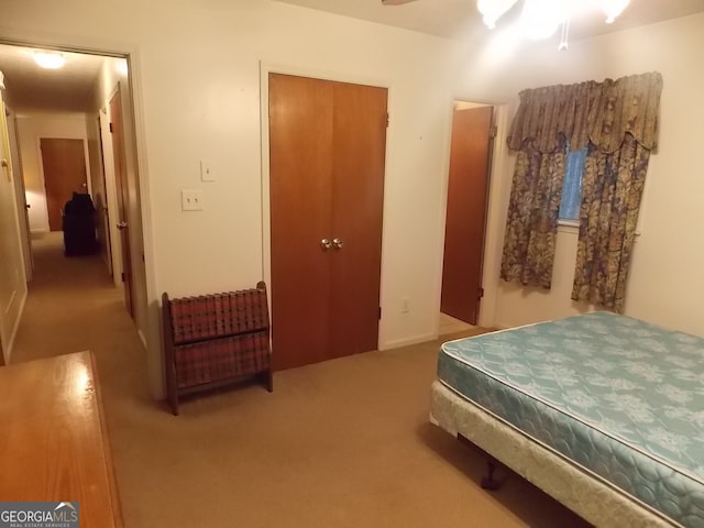 bedroom featuring carpet, ceiling fan, and a closet