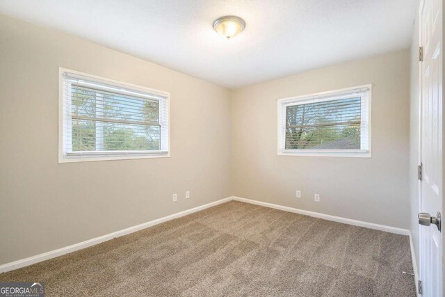 2910 Delowe Dr, Atlanta, GA 30344 - spare room featuring carpet flooring and baseboards