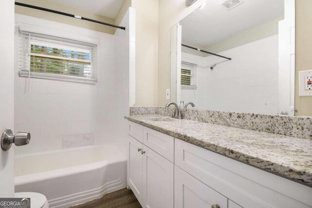 2910 Delowe Dr, Atlanta, GA 30344 - full bathroom featuring vanity, washtub / shower combination, wood finished floors, and toilet