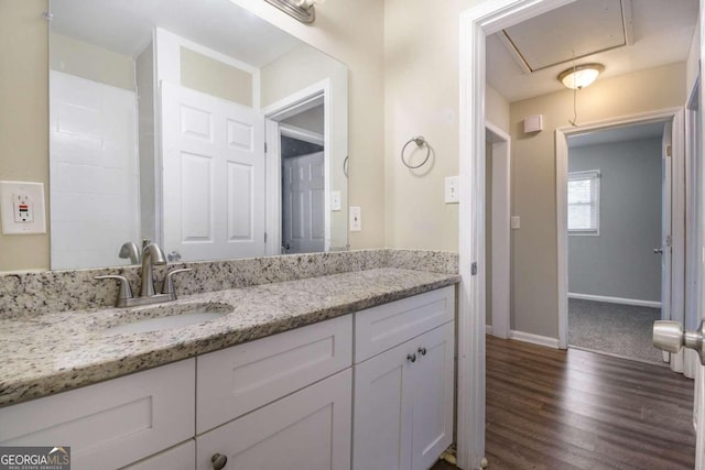 2910 Delowe Dr, Atlanta, GA 30344 - bathroom featuring vanity, wood finished floors, and baseboards