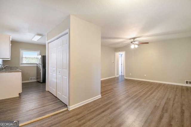 2910 Delowe Dr, Atlanta, GA 30344 - unfurnished living room with dark wood finished floors, a ceiling fan, baseboards, and a sink