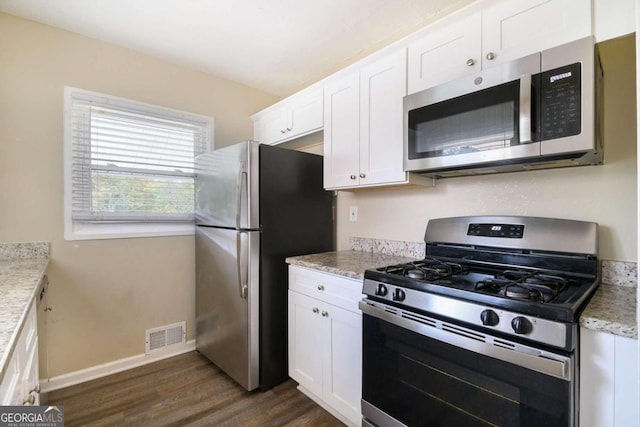 2910 Delowe Dr, Atlanta, GA 30344 - kitchen featuring stainless steel appliances, dark wood finished floors, white cabinetry, baseboards, and light stone countertops