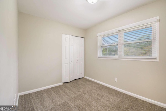 2910 Delowe Dr, Atlanta, GA 30344 - unfurnished bedroom featuring carpet, baseboards, and a closet