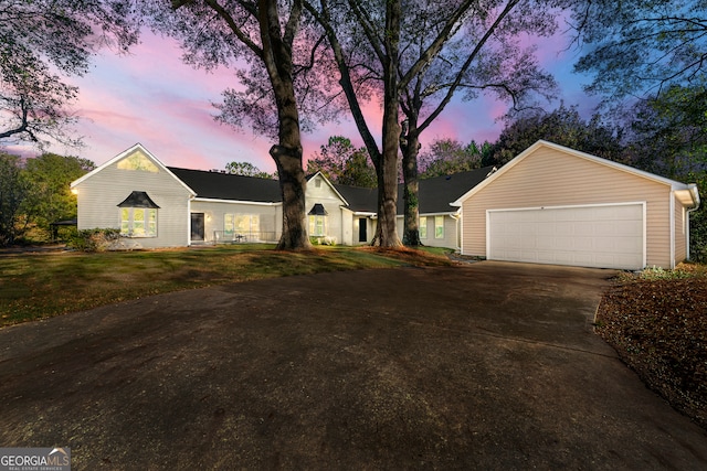 single story home with a lawn and a garage