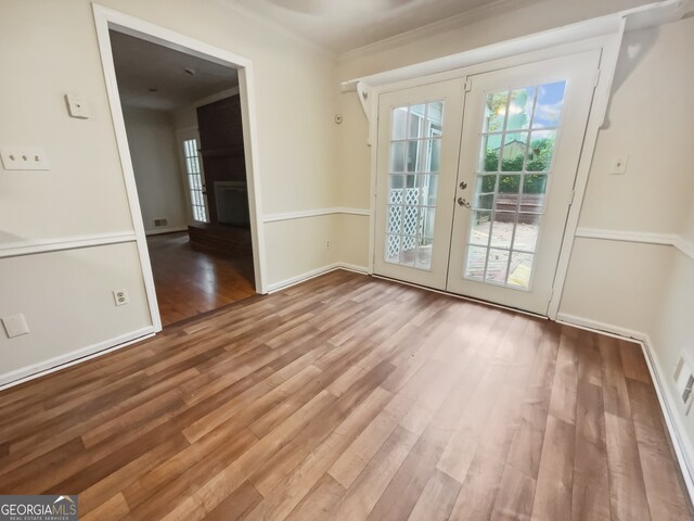 doorway to outside featuring light hardwood / wood-style flooring, french doors, and ornamental molding