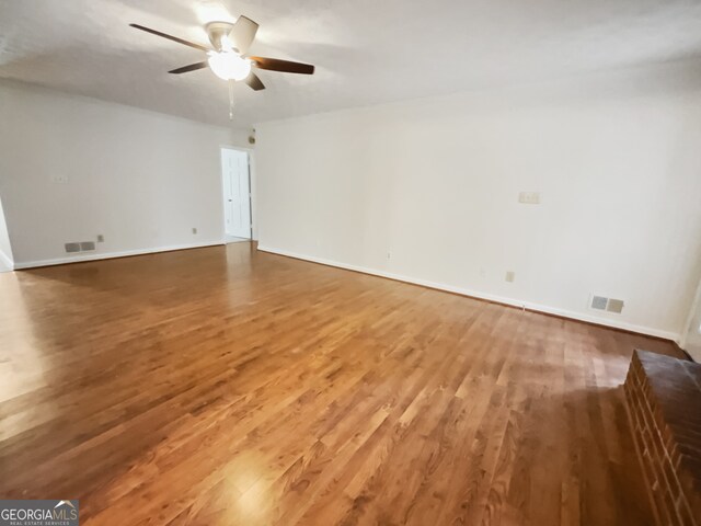 empty room featuring hardwood / wood-style flooring and ceiling fan