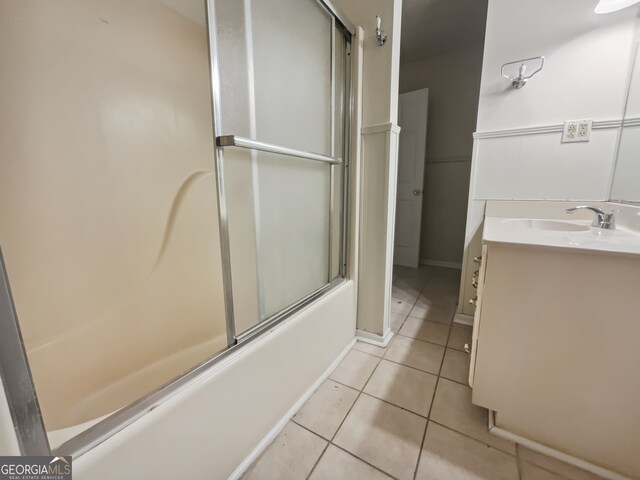 bathroom featuring vanity, enclosed tub / shower combo, and tile patterned flooring