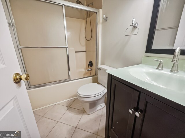 full bathroom with toilet, enclosed tub / shower combo, tile patterned floors, and vanity