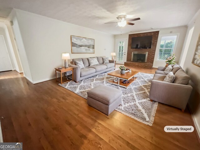 living room with hardwood / wood-style floors, a fireplace, and ceiling fan