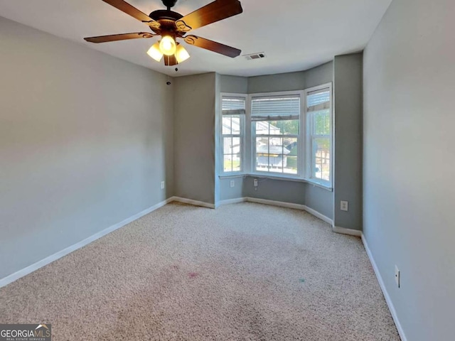 empty room with light carpet and ceiling fan