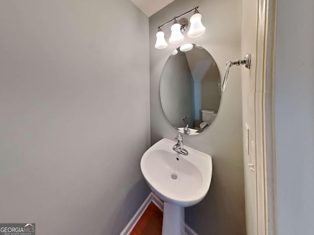 bathroom featuring toilet and hardwood / wood-style flooring