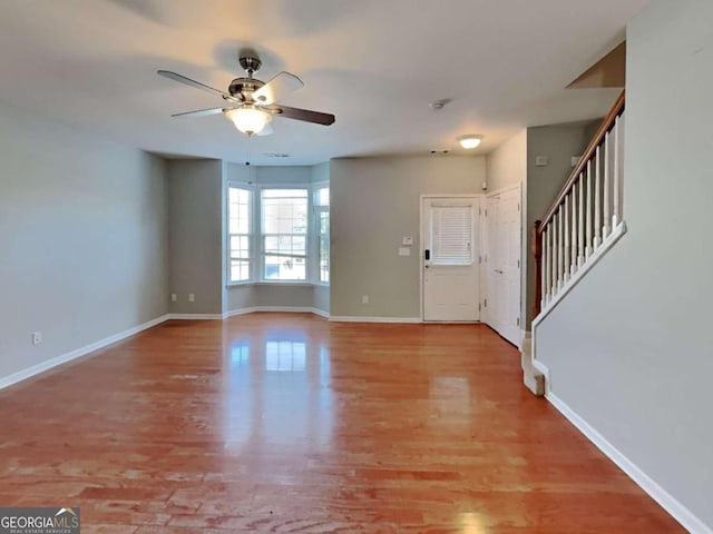 foyer entrance with ceiling fan and light hardwood / wood-style flooring