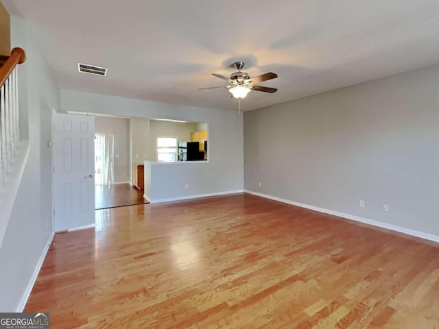 unfurnished living room featuring light hardwood / wood-style floors and ceiling fan