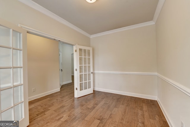 spare room with light hardwood / wood-style floors, french doors, and crown molding