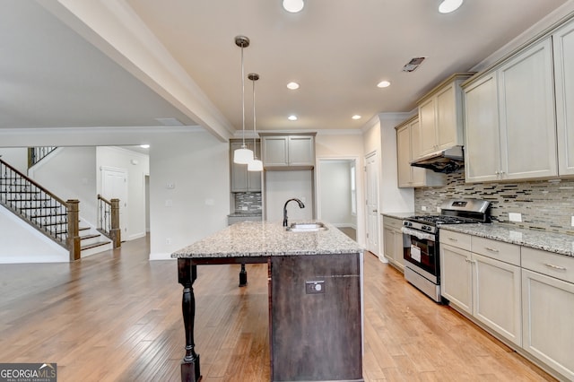 kitchen featuring light stone countertops, stainless steel gas range, and light hardwood / wood-style floors