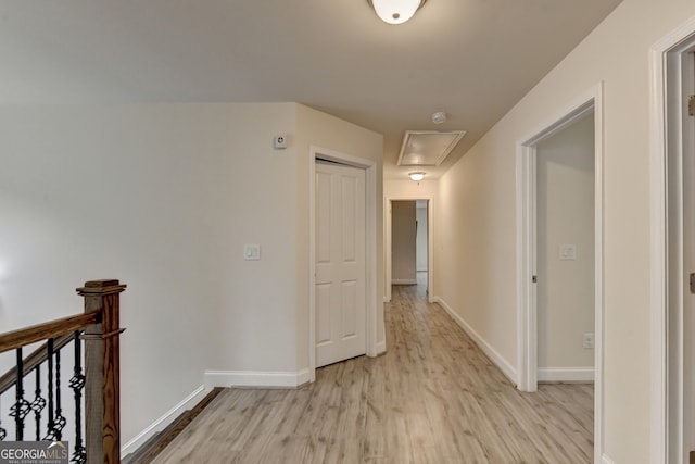 hallway with light hardwood / wood-style flooring