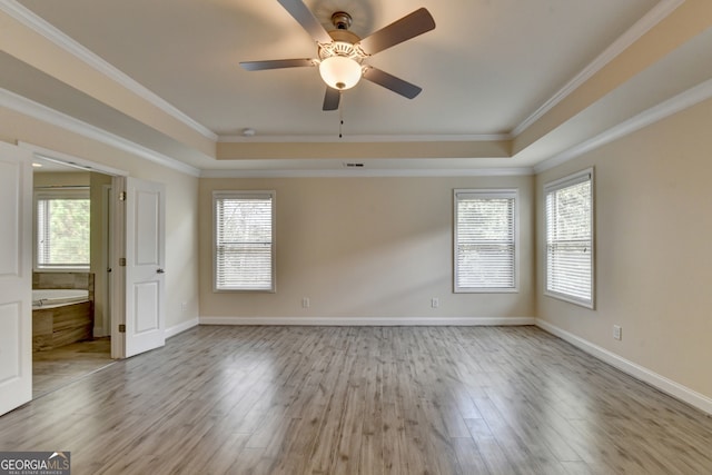 unfurnished room featuring light hardwood / wood-style floors, ceiling fan, plenty of natural light, and ornamental molding