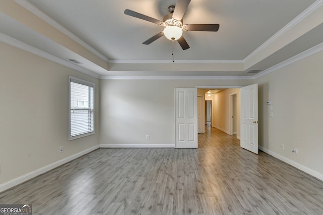 interior space featuring light hardwood / wood-style floors, a raised ceiling, ceiling fan, and crown molding