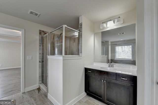 bathroom featuring walk in shower, vanity, and hardwood / wood-style flooring