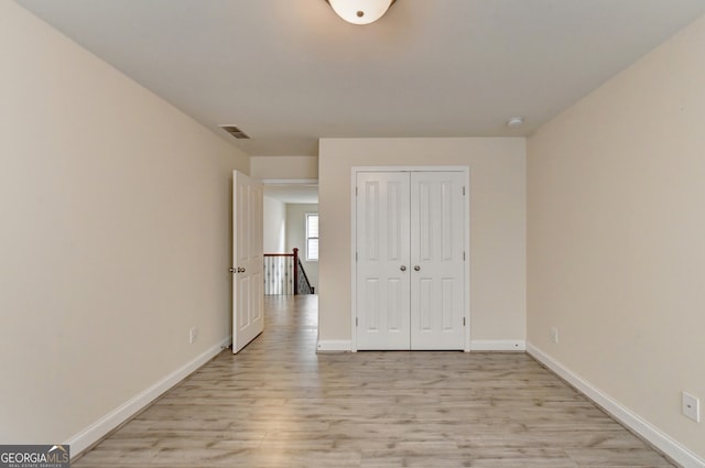 interior space with light wood-type flooring and a closet