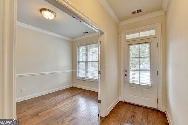 doorway featuring ornamental molding and light hardwood / wood-style floors