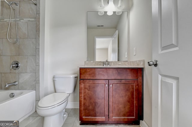 full bathroom featuring toilet, vanity, tiled shower / bath, and tile patterned floors