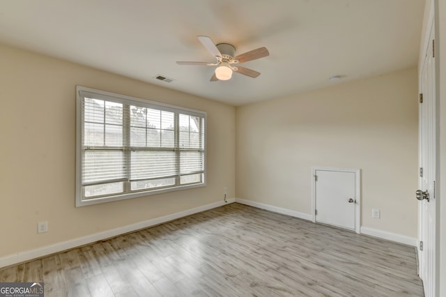 spare room with light hardwood / wood-style flooring and ceiling fan