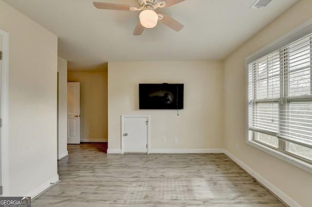 unfurnished living room with light wood-type flooring and ceiling fan