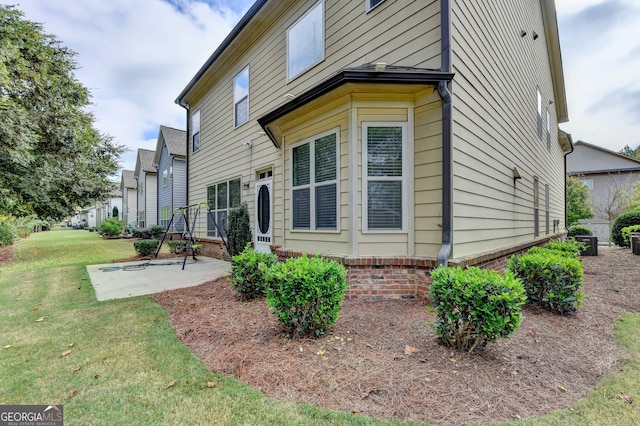 exterior space featuring a lawn and a patio area