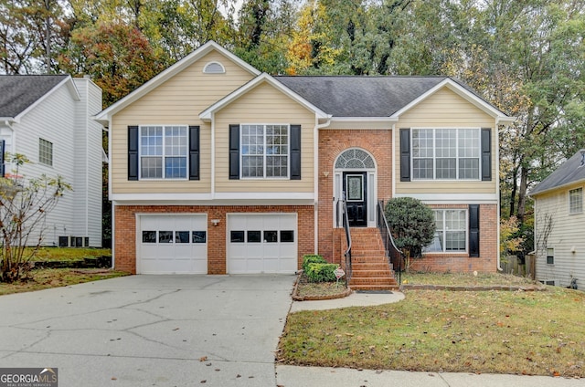 split foyer home with a front lawn, a garage, and cooling unit