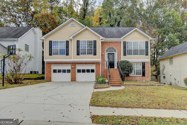 raised ranch with a garage and a front yard