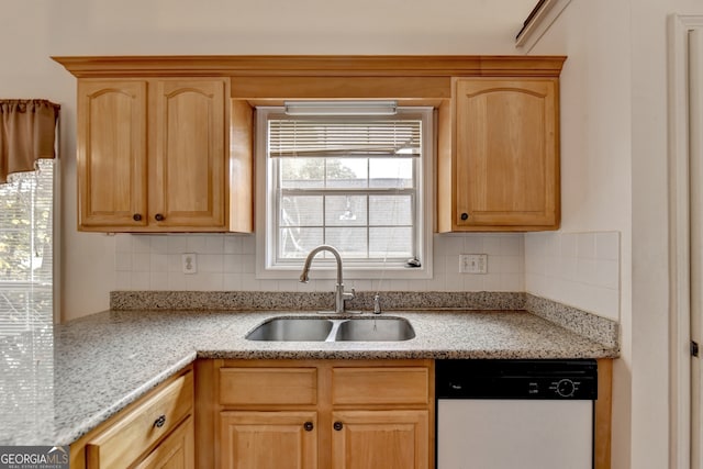 kitchen with dishwasher, tasteful backsplash, sink, and light brown cabinetry