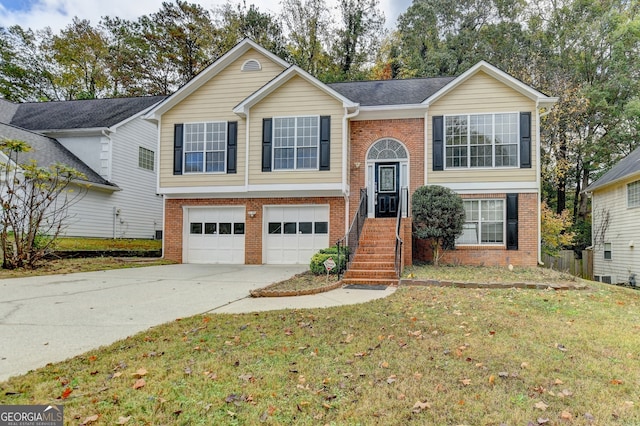 split foyer home with a front lawn and a garage