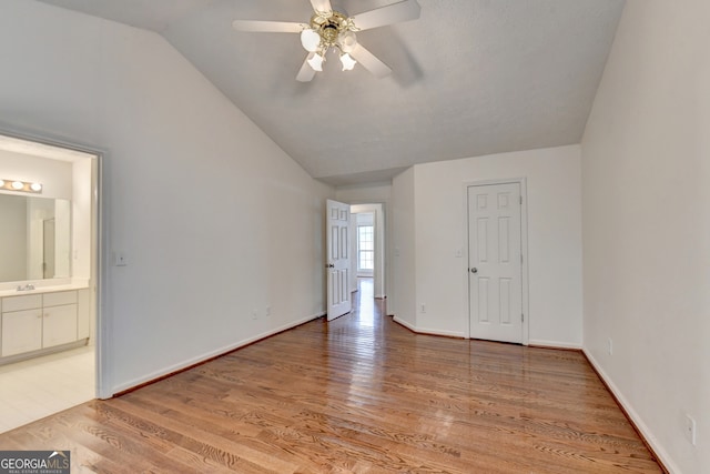 spare room featuring hardwood / wood-style floors, ceiling fan, and lofted ceiling