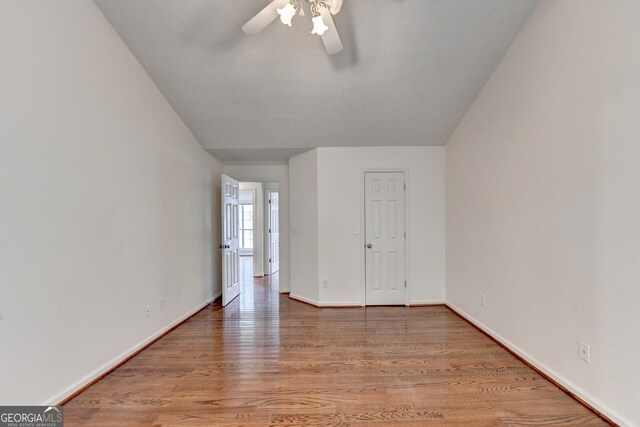 unfurnished room featuring hardwood / wood-style floors and ceiling fan