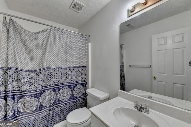 bathroom featuring vanity, a shower with shower curtain, a textured ceiling, and toilet