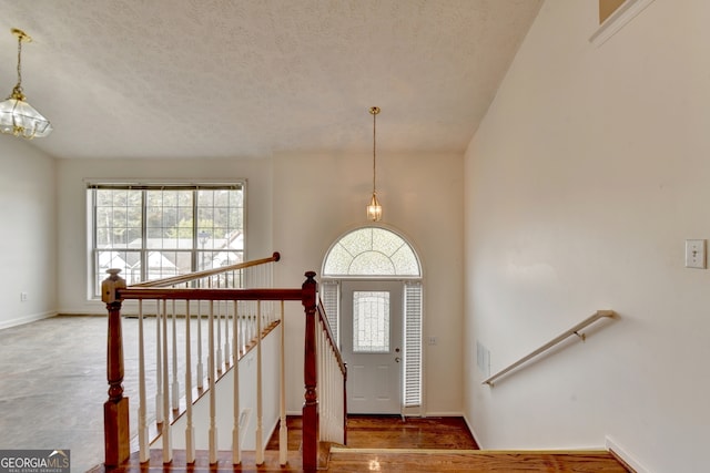 entryway featuring a textured ceiling and hardwood / wood-style flooring