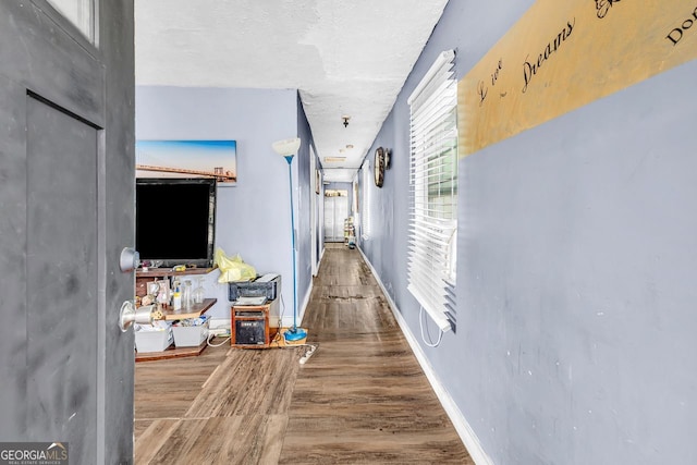 hallway with hardwood / wood-style flooring