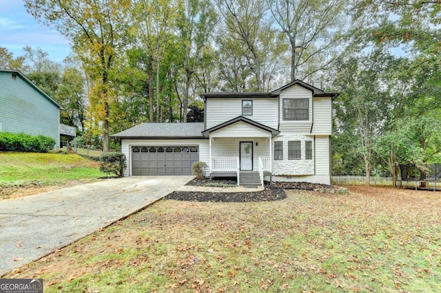 view of front property featuring a garage, a porch, and a front lawn