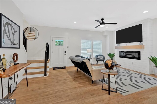 living room featuring light wood-type flooring and ceiling fan