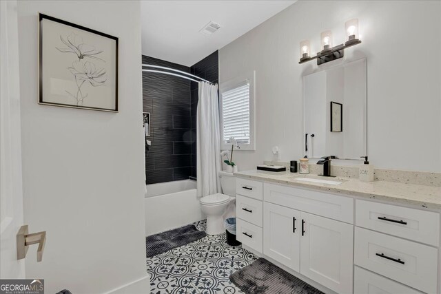 full bathroom featuring vanity, tile patterned flooring, toilet, and shower / bath combination with curtain